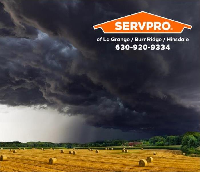 Farm field with dark storm clouds in the background.