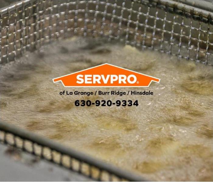 Deep fryer with hot oil and an orange SERVPRO logo.